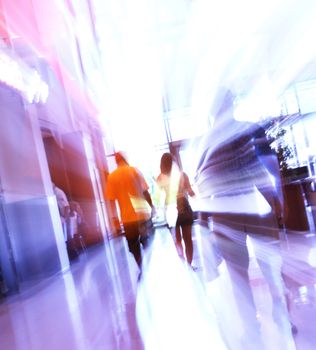 blurred unrecognizable people in motion in a shopping mall