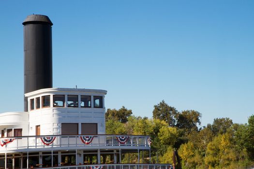 Front or Forward deck of old classic river boat with stove pipe and American flag