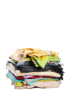 Colorful stack of dirty bed-clothes is ready for laundry. Isolated on white background