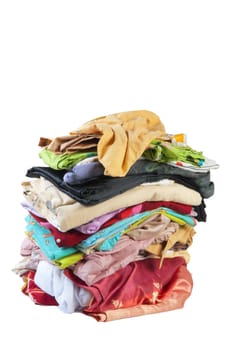 Colorful stack of dirty bed-clothes is ready for laundry. Isolated on white background