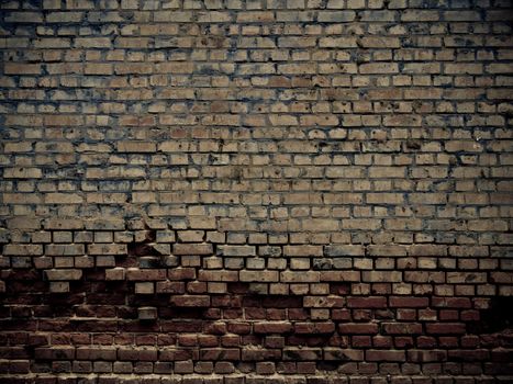 Old grunge crumbling brick wall
