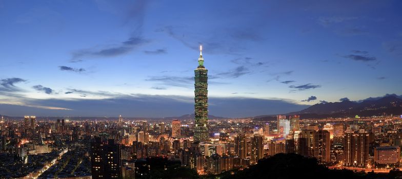 Panoramic city skyline in night with famous 101 skyscraper and buildings in Taipei, Taiwan.