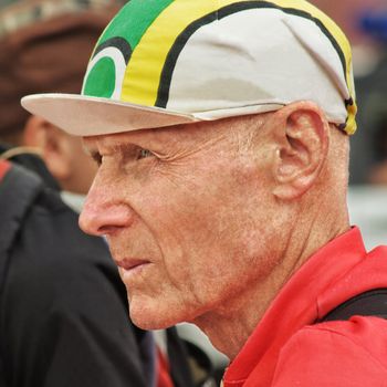 Portrait of the confident elderly man in a cap