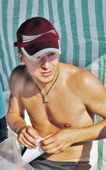 The thoughtful young guy under tent - summer day