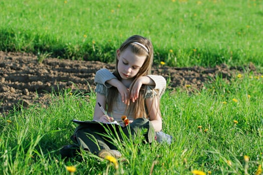 Brother and sister enjoy summer time in the green grass.