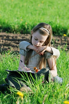 Brother and sister enjoy summer time in the green grass.