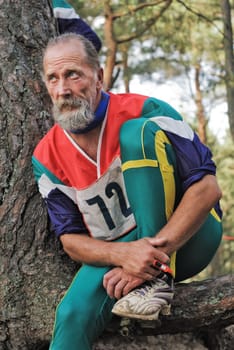 The sportsman on rest sits on the road brink
