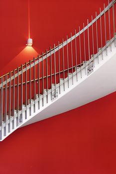 white stair with red wall and one light