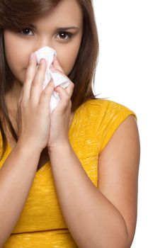 Hispanic teen girl blowing nose