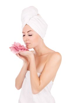 Woman after bath with towel and flower isolated on white