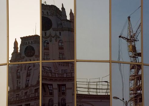 In glass of the station square buildings of Minsk city are reflected