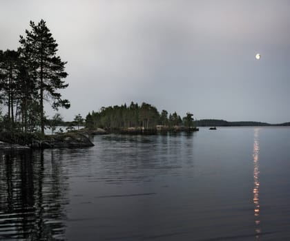 The moon and its reflexion over northern lake