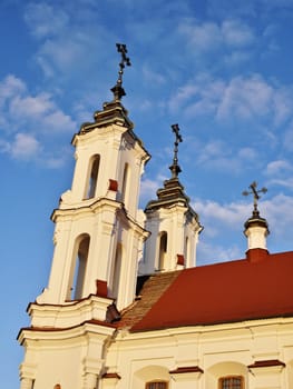white church with red roof  under warm sunrise rays