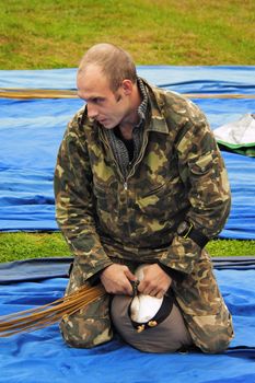 The serious man-parachutist prepares a parachute for a jump