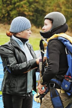 Two serious girls communicate before parachute jump