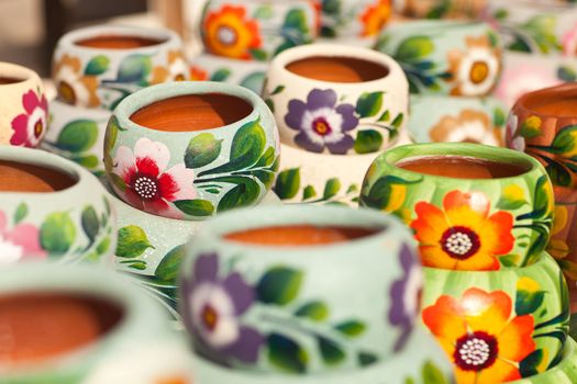 Variety of Colorfully Painted Ceramic Pots in an Outdoor Shopping Market.