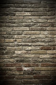 A wall of aged grey and red bricks