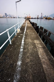 Deserted jetty at a foggy sea near a dutch city. hongkong