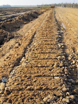 Trace from the building technics on a ground of constructed road