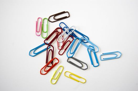 Many colored paper clips isolated on white