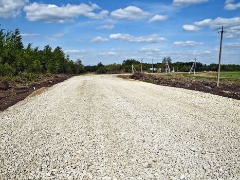 Road covered with a small stone before laying of an asphalt covering