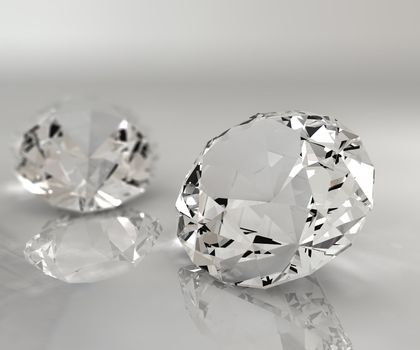 Two diamonds isolated on a reflective table