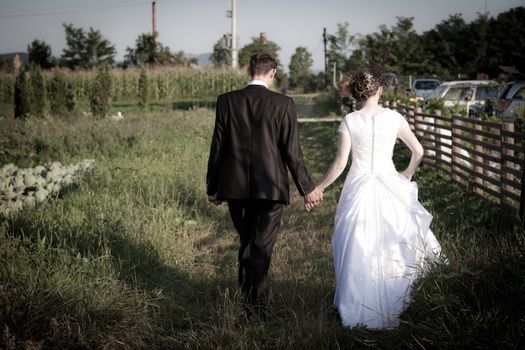 Young married couple walking on a countryside trail