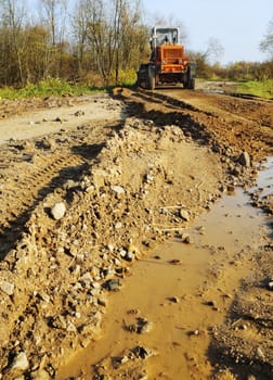 The grader levels gravel at road building
