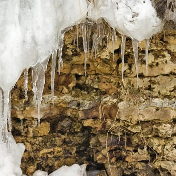 Ice icicles hang down over a calcareous (dolomite) rock