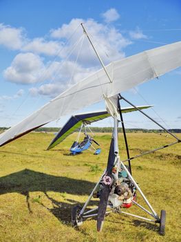 The motor hang-gliders on green airfield