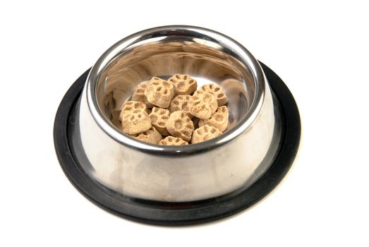 Some dog food in the shape of paws in a metal bowl, isolated against a white background.