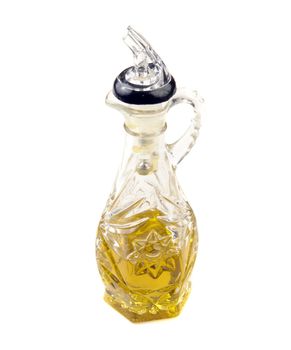 A glass container filled with olive oil, isolated against a white background