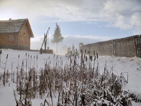 February blizzard in village on reed lake coast