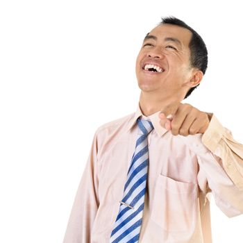 Mature business man laughing and pointing with copyspace on white.