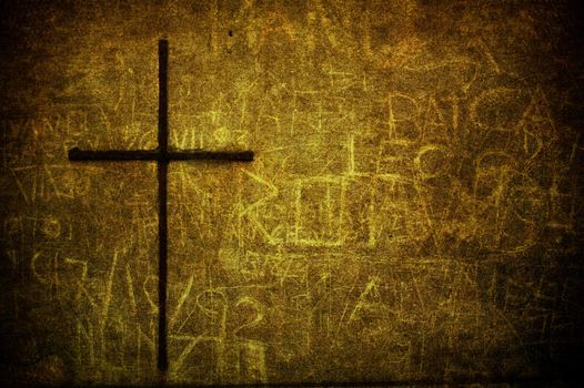 A cracked yellow grunge wall with metal cross