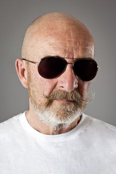 An old man with a grey beard sunglasses