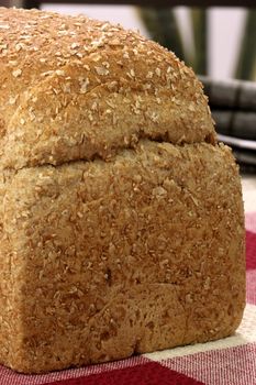 fresh baked  whole grain bread with oats pine nuts and lots of assorted healthy grains 