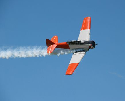 Aerobatic Plane with smoke trail. The cocpit is open