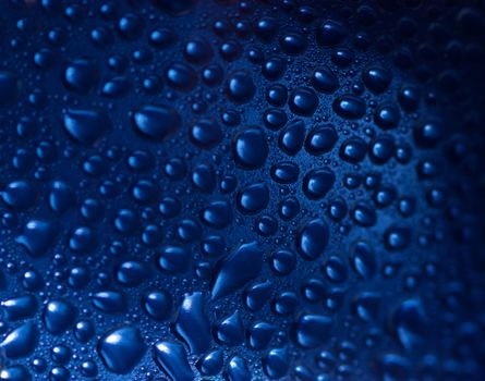 Blue abstract background. Condensate drops on a curved surface.
