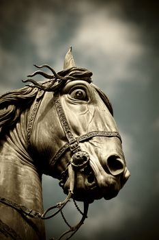 A horse head statue isolated over a blue sky