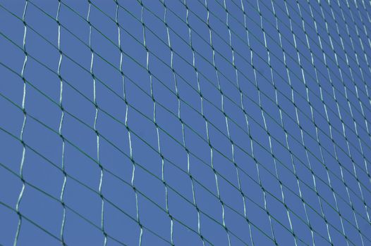 A green net with a blue sky in backround