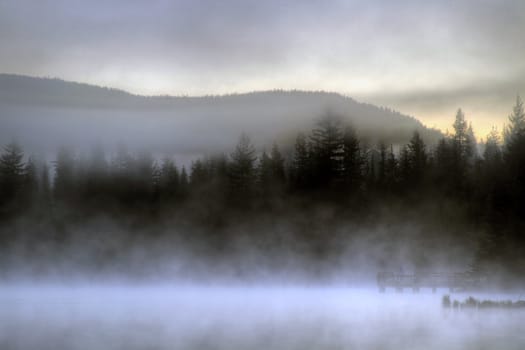 Waiting for Sunrise on the Dock at Trillium Lake one Foggy Morning