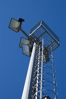 Lights on a pylon under a blue sky