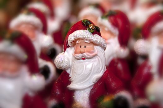 Many little statue of santa clause and one in focus