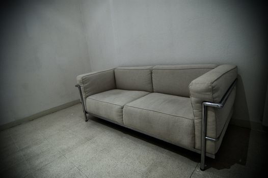 A grey sofa in a grey room
