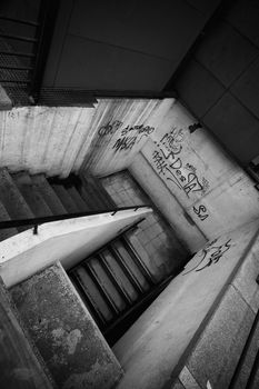 A grunge black and white stair with some graffiti
