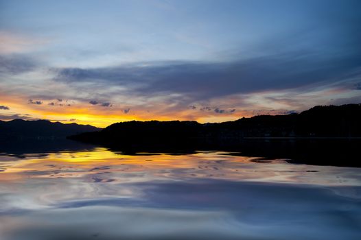 A yellow sunset over the calm sea