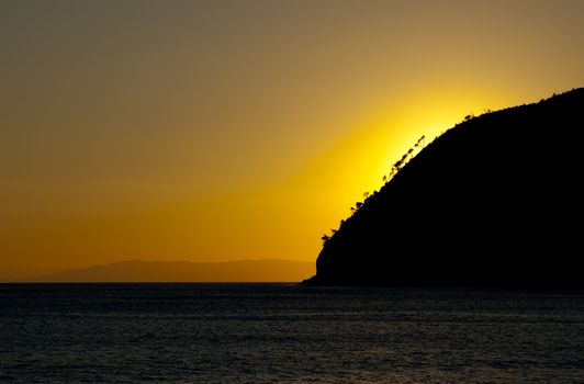 An orange and yellow sunset over a calm sea