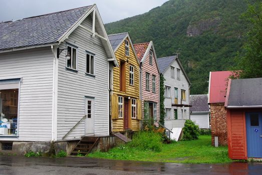 Traditional wooden houses on hillside background in Lyrdal, Norway