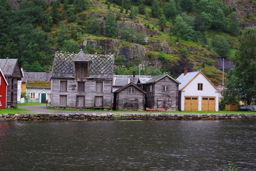 Traditional wooden houses on hillside background in Lyrdal, Norway